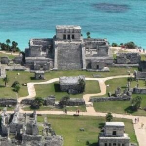 A breathtaking view of the ancient ruins of Tulum overlooking the turquoise waters of the Caribbean Sea.