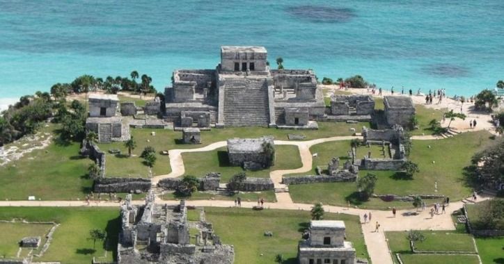 A breathtaking view of the ancient ruins of Tulum overlooking the turquoise waters of the Caribbean Sea.